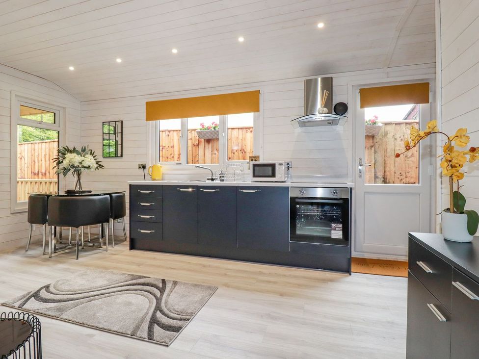 A kitchen with table and chairs at St. Chad's Lodge in Bodmin