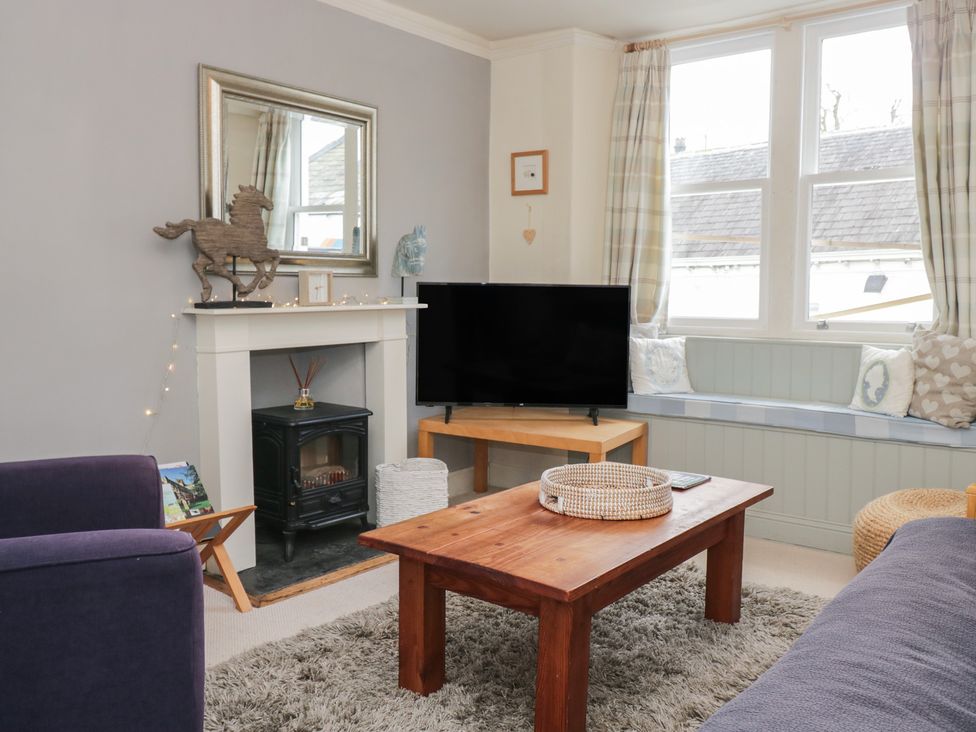 A living room with a coffee table and television at Flat 4 Tower House Grange-Over-Sands