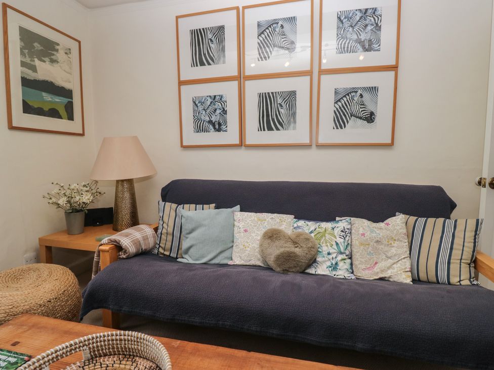 A living room with a sofa and wall art at Flat 4 Tower House, Grange-Over-Sands