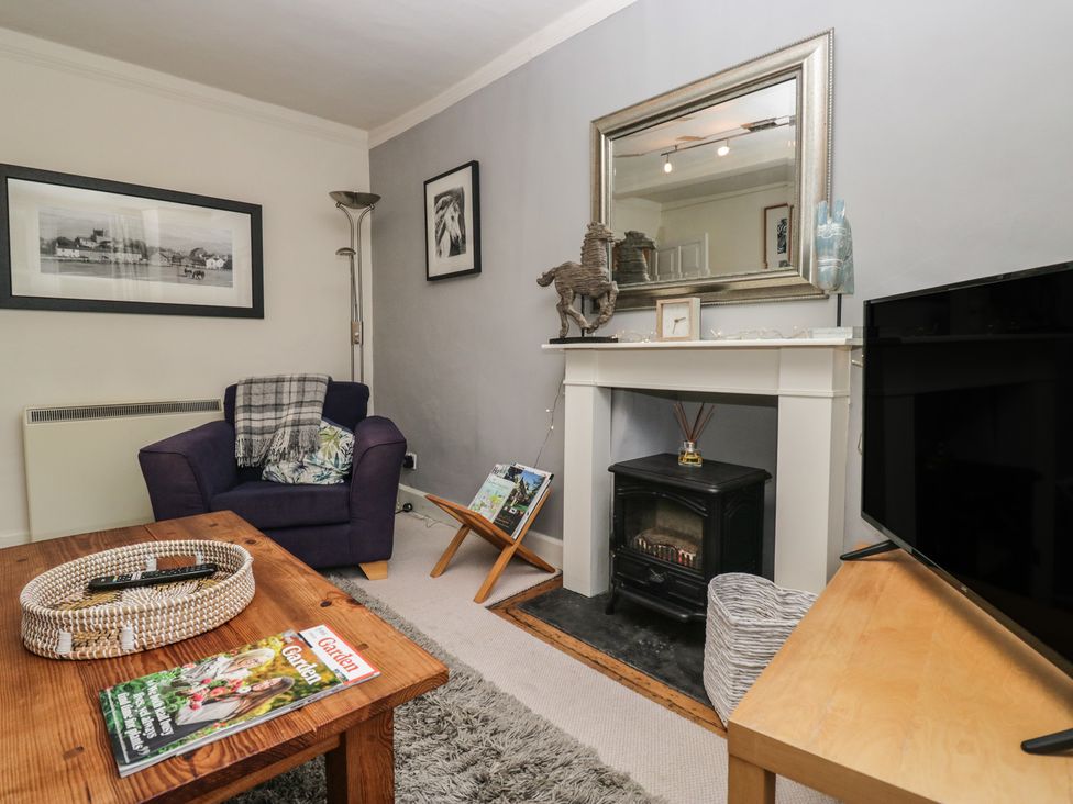 A living room with a sofa and fireplace at Flat 4 Tower House in Grange-Over-Sands