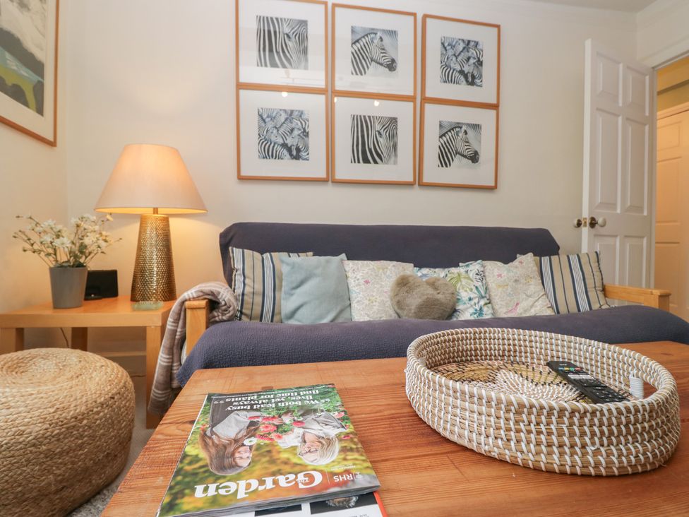 A living room with a sofa and wall art at Flat 4 Tower House in Grange-Over-Sands
