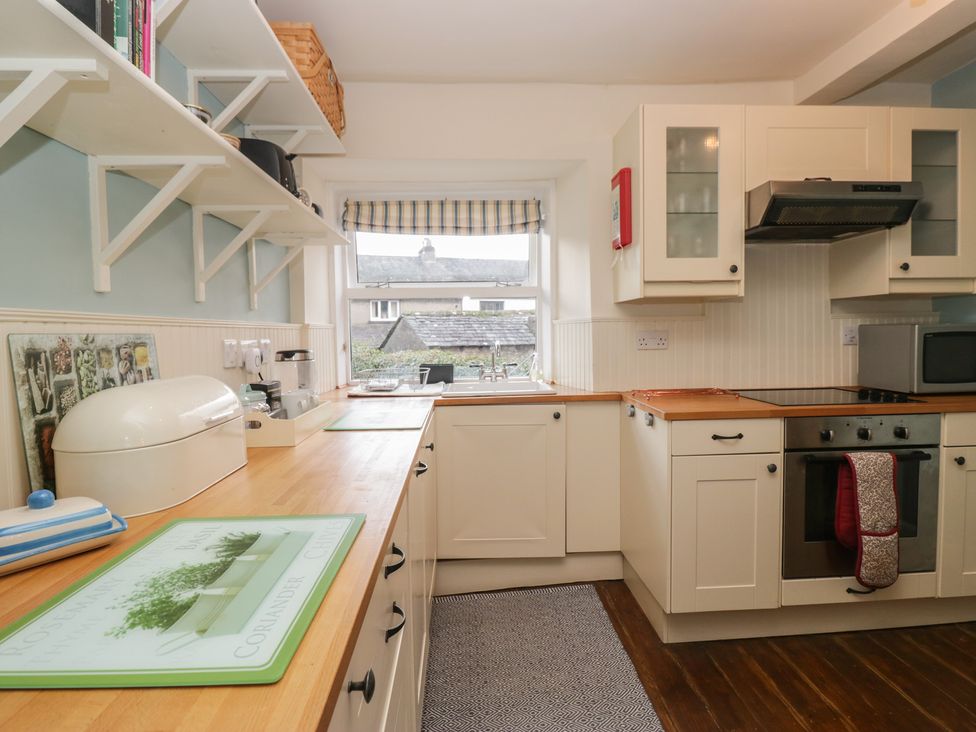 A kitchen with a window and appliances at Flat 4 Tower House Grange-Over-Sands