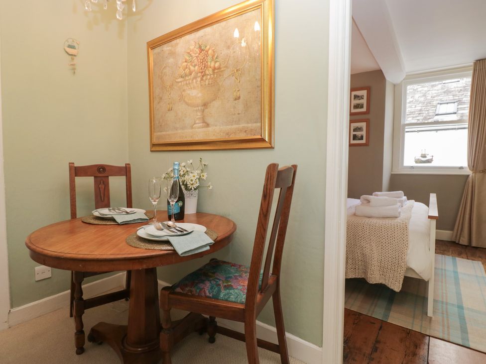 A dining room with a table and chairs at Flat 4 Tower House in Grange-Over-Sands
