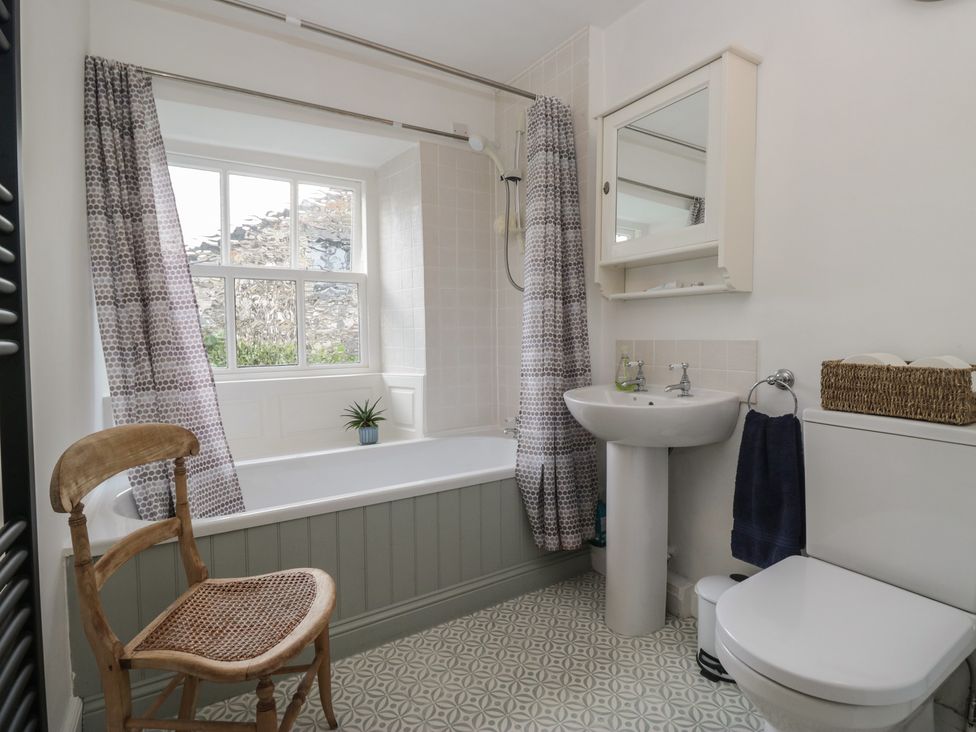 A bathroom with a bathtub and sink at Flat 4 Tower House in Grange-Over-Sands