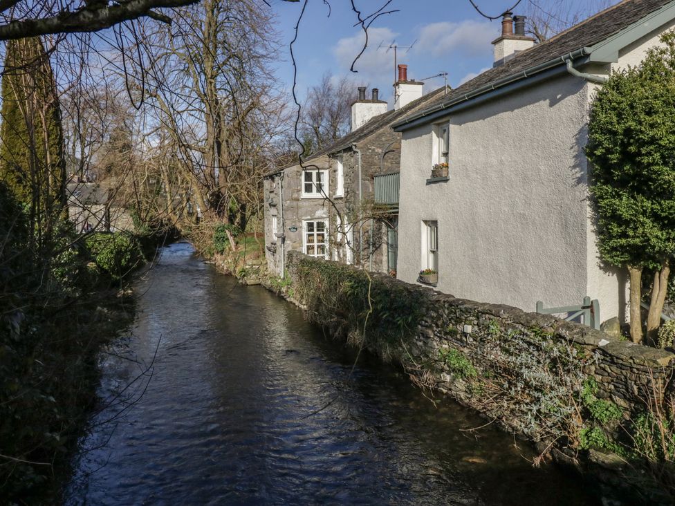Houses near a stream with trees at Flat 4 Tower House in Grange-Over-Sands