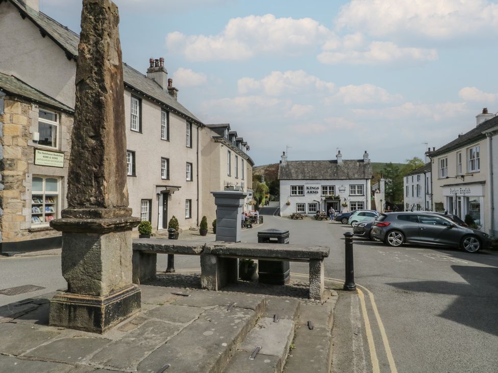 A street view with buildings and vehicles at Flat 4 Tower House Grange-Over-Sands