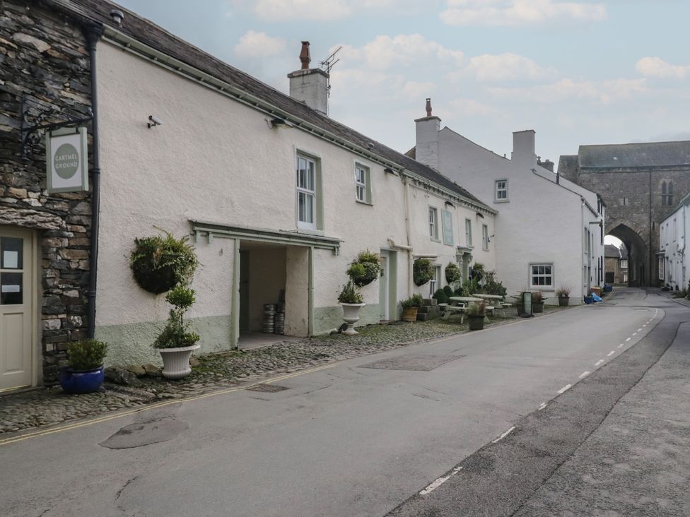 A street view with buildings and plants at Cartmel Ground in Grange-Over-Sands