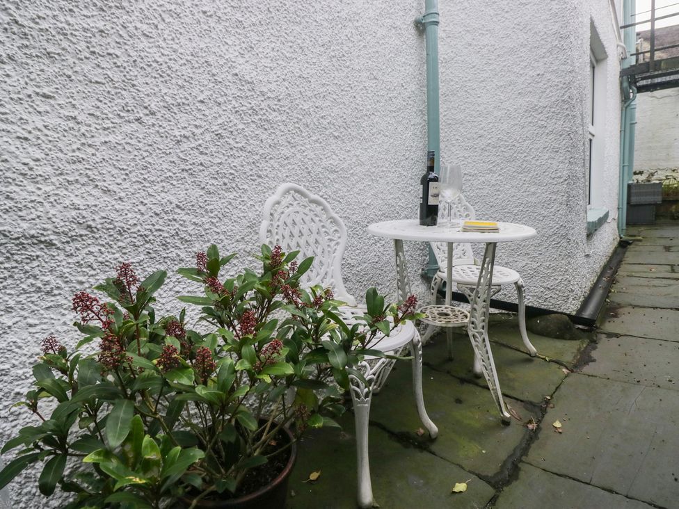 An outdoor area with a table and chairs at Flat 4 Tower House in Cartmel