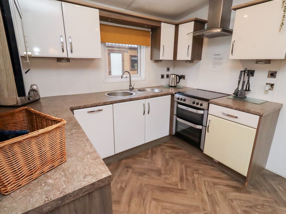 A kitchen with a sink and oven at Chloe's Cabin Felmoor Holiday Park near Felton
