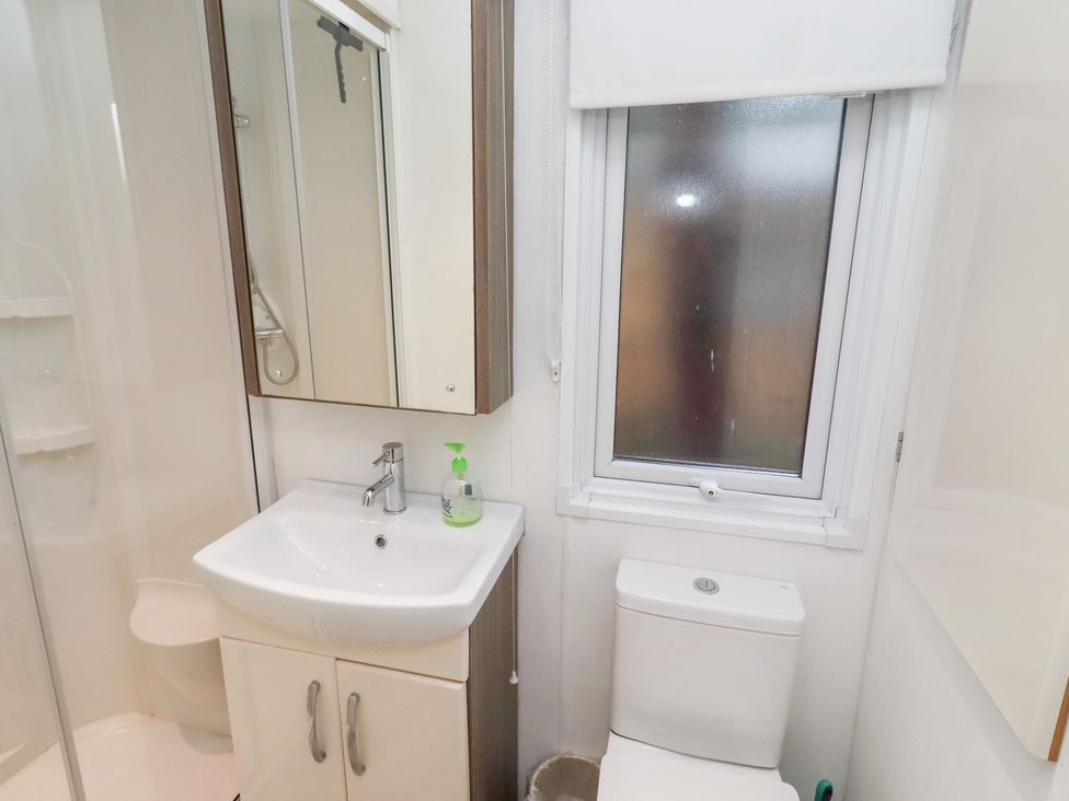 A bathroom with a sink and toilet at Chloe's Cabin Felmoor Holiday Park near Felton
