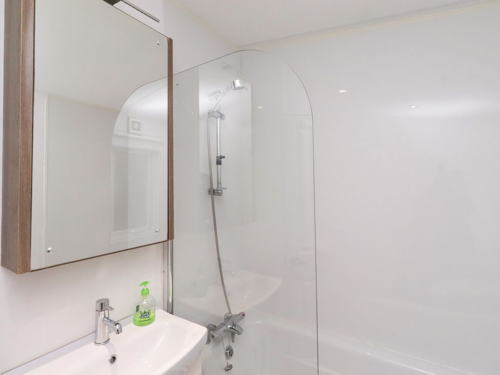 A bathroom with a sink and shower at Chloe's Cabin near Felmoor Holiday Park