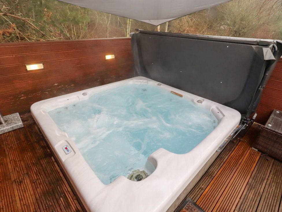 A hot tub on wooden decking at Chloe's Cabin near Felmoor Holiday Park