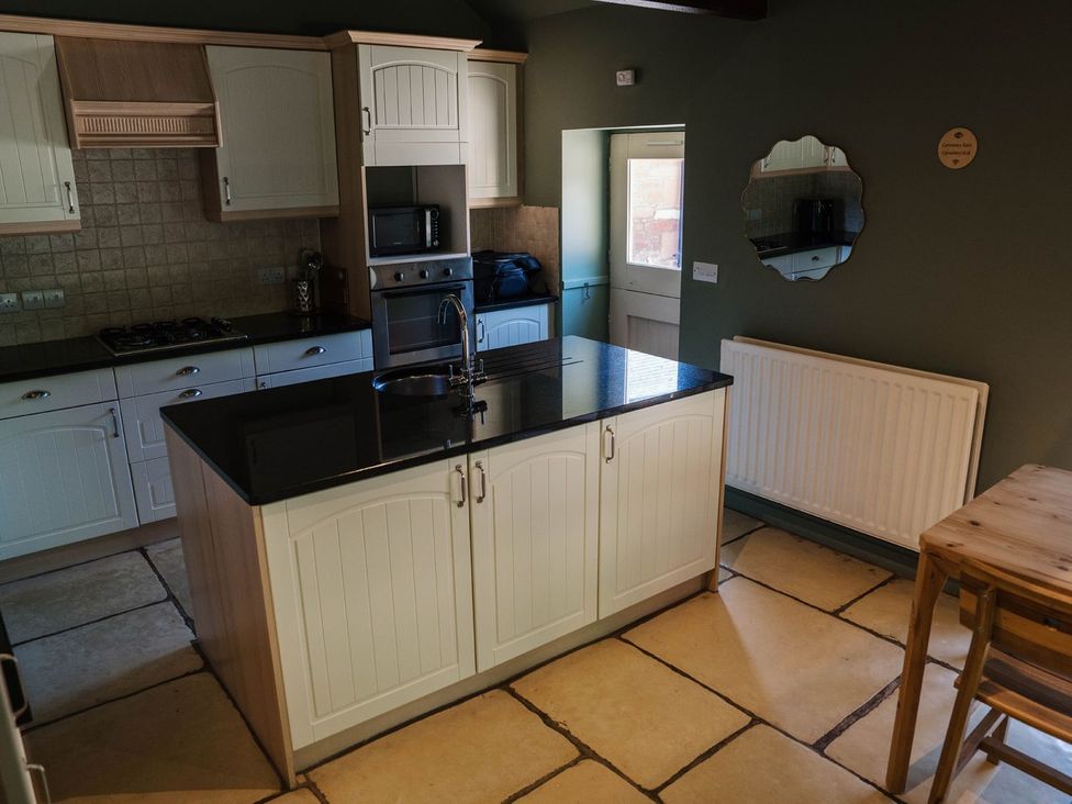 A kitchen with a large island and appliances at Carwinley Mill House Cottage Carwinley near Longtown