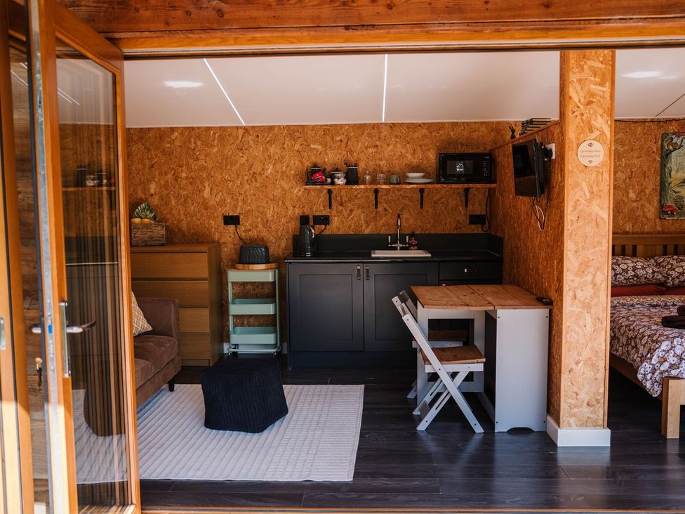 A studio with a kitchenette and seating area at The Chard in Carlisle