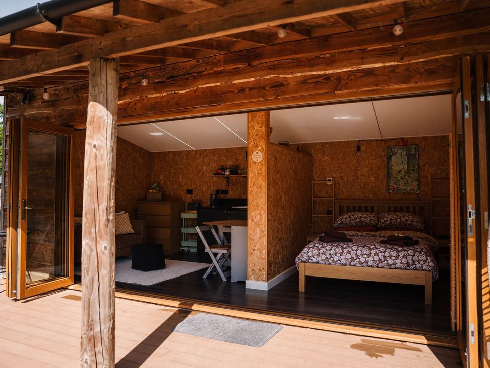 A bedroom with a bed and a small seating area at The Chard in Carlisle