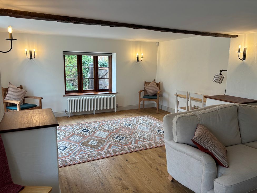 A living room with a sofa and chairs at Manor Cottage in Bampton, Oxfordshire