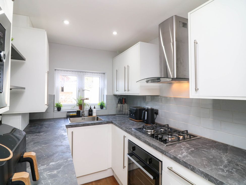 A kitchen with a sink and cooking area at 11 Regent Street in Melton Mowbray