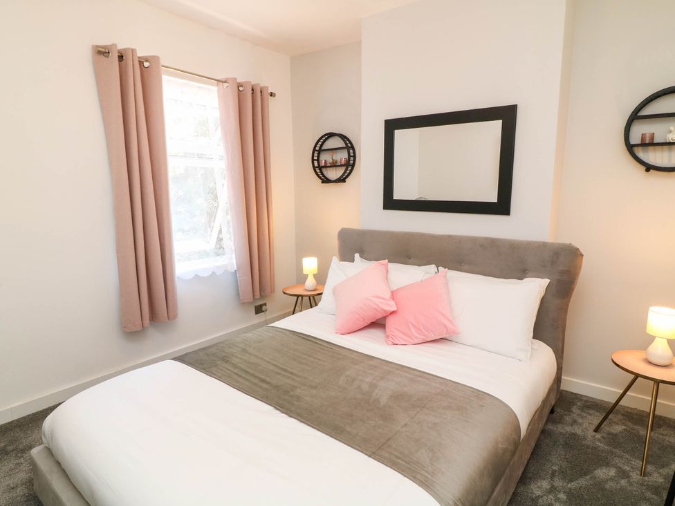 A bedroom with a bed, pillows, and a lamp at 11 Regent Street, Melton Mowbray