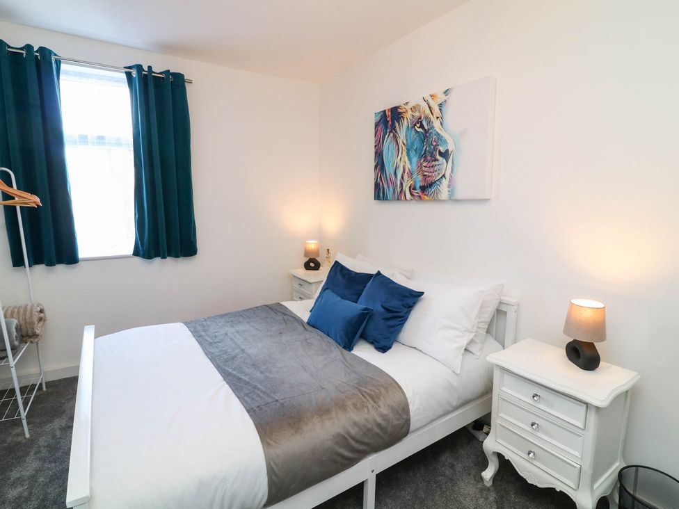 A bedroom with a bed and nightstand at 11 Regent Street Melton Mowbray