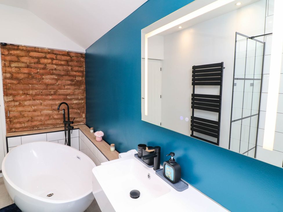 A bathroom with a bathtub and sink at 11 Regent Street in Melton Mowbray