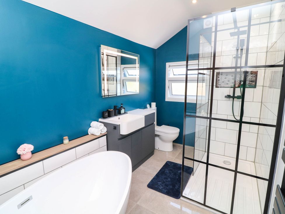 A bathroom with a bathtub, shower, and sink at 11 Regent Street in Melton Mowbray
