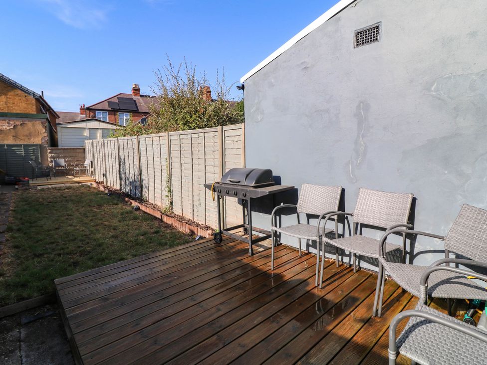 A garden with chairs and a grill at 11 Regent Street, Melton Mowbray