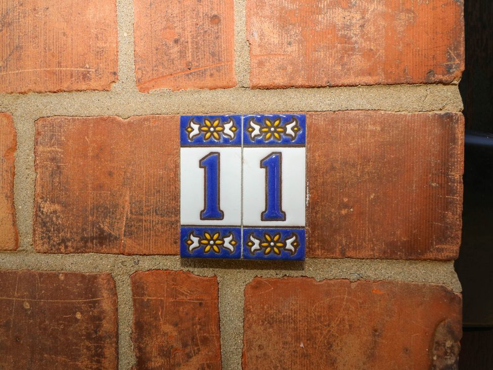 Number 11 tiles on a brick wall at 11 Regent Street Melton Mowbray