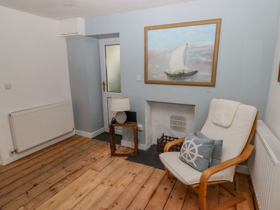 A living room with a painting and an armchair at Rock House in Narberth