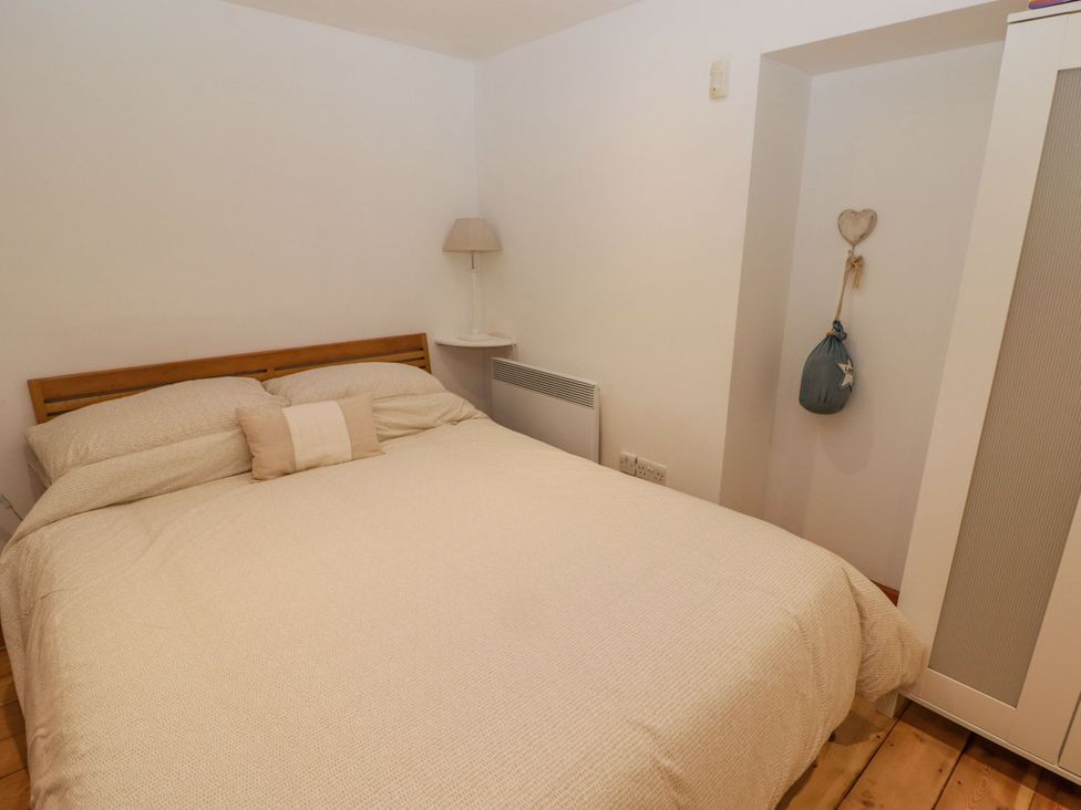 A bedroom with a bed and nightstand at Rock House in Narberth