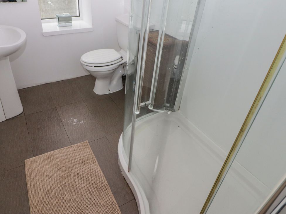 A bathroom with a sink, toilet, and shower at Rock House in Narberth