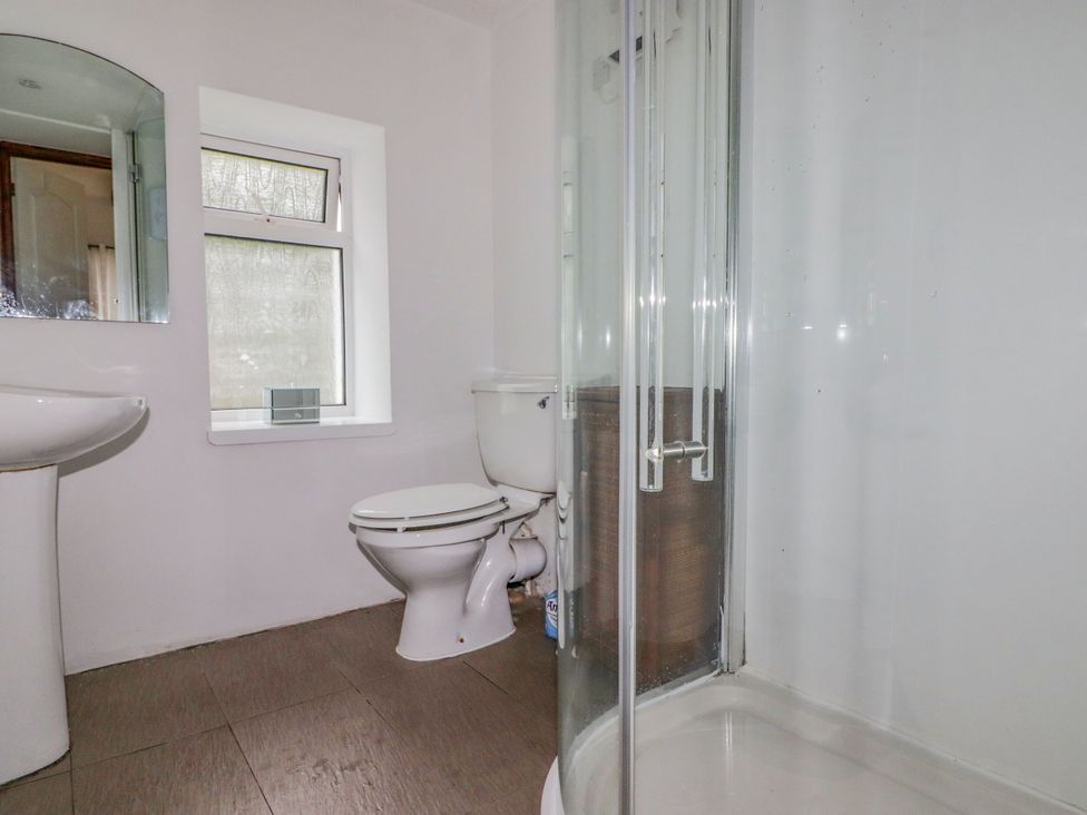 A bathroom with a sink, toilet, and shower at Rock House in Narberth