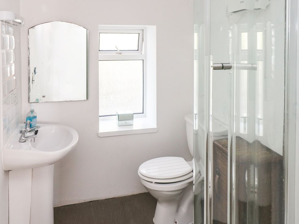 A bathroom with a sink, toilet, and shower at Rock House in Narberth