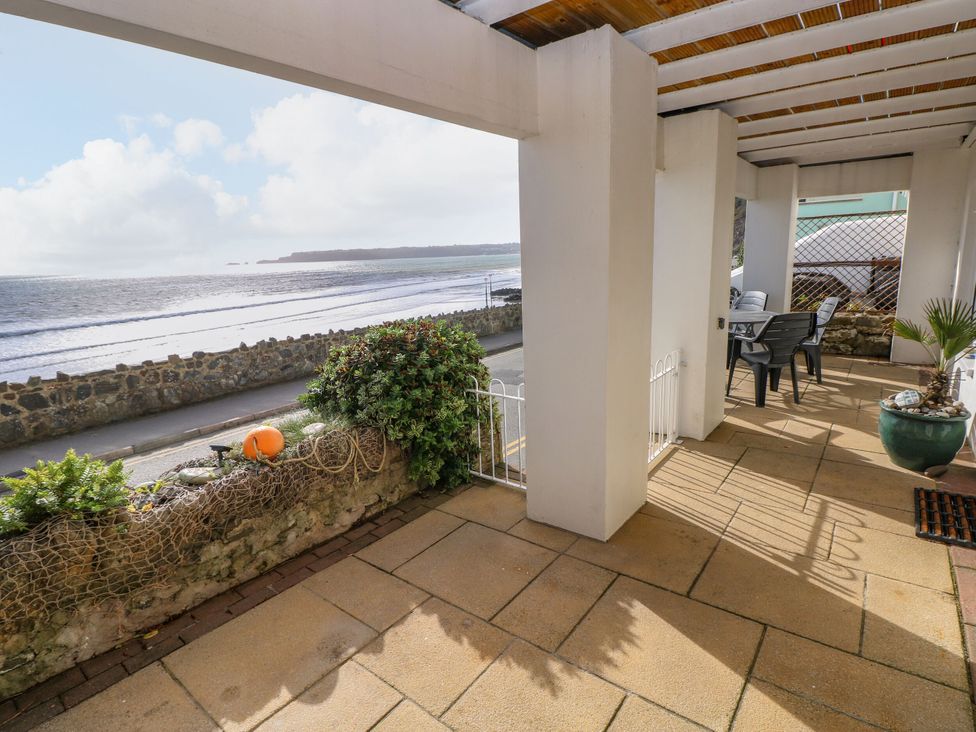A patio overlooking the ocean at Rock House in Narberth