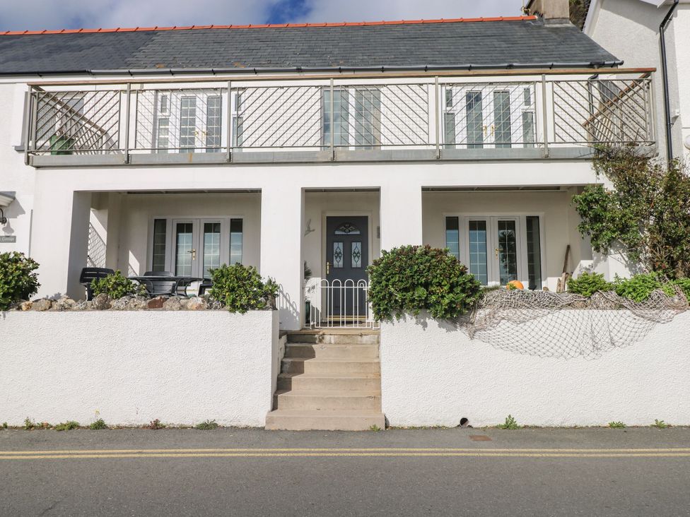 An exterior view of a house with a balcony and a front door at Rock House in Narberth