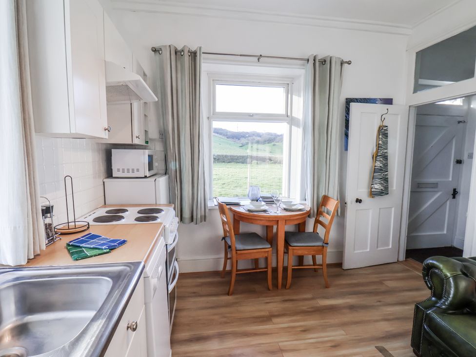 A kitchen with a table and chairs at Hornblower Lodge in Whitby