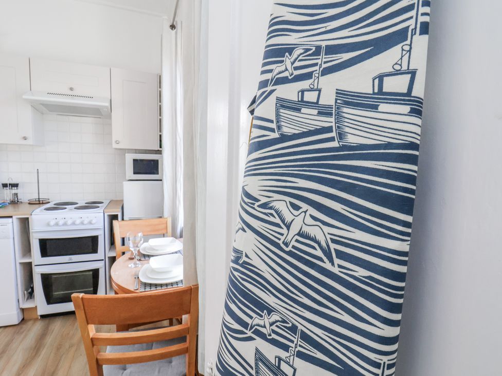 A kitchen with a dining table and chairs at Hornblower Lodge in Whitby