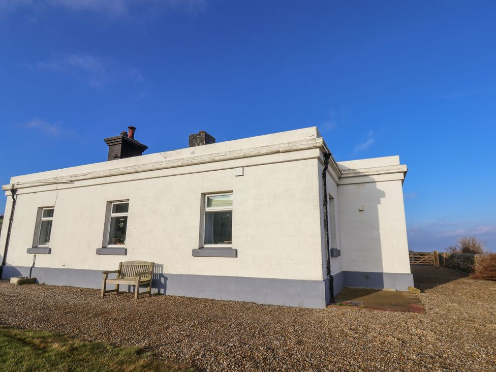 An exterior view of a house with a bench in Whitby at Hornblower Lodge