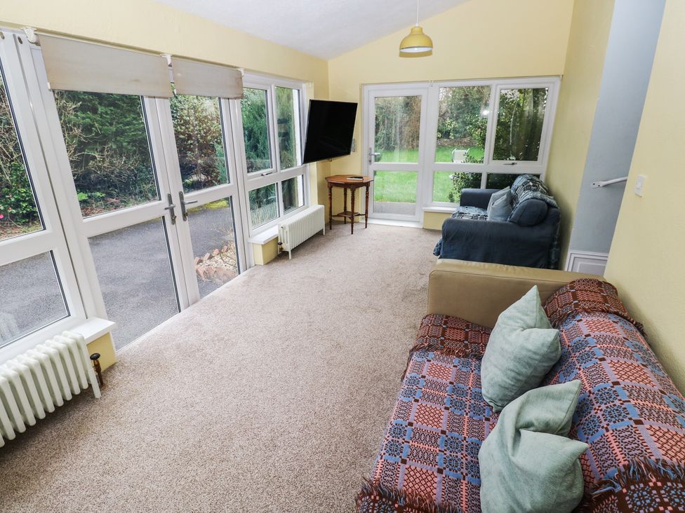 A snug with sofas and a table at Kenvor, Newport, Pembrokeshire