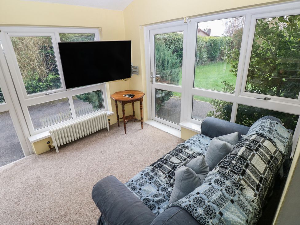 A snug with a television and a sofa at Kenvor in Newport, Pembrokeshire