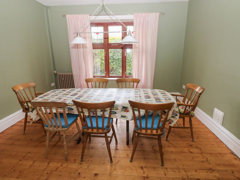 A dining room with a table and chairs at Kenvor Newport, Pembrokeshire