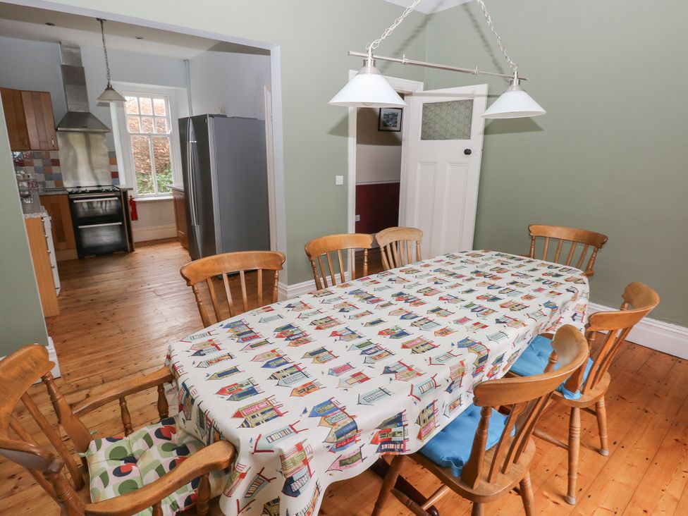 A dining room with a large table and chairs at Kenvor in Newport, Pembrokeshire