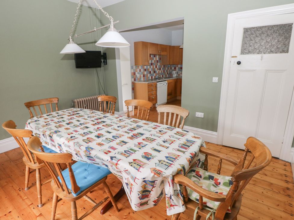 A dining room with a table and chairs at Kenvor in Newport, Pembrokeshire
