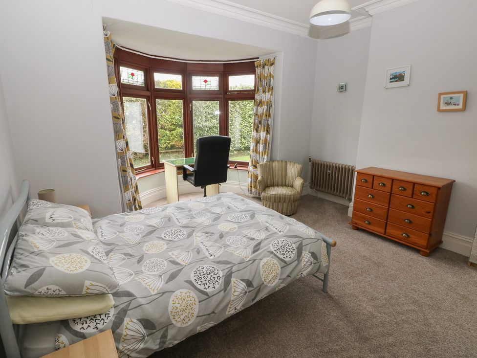 A bedroom with a bed and desk at Kenvor in Newport, Pembrokeshire