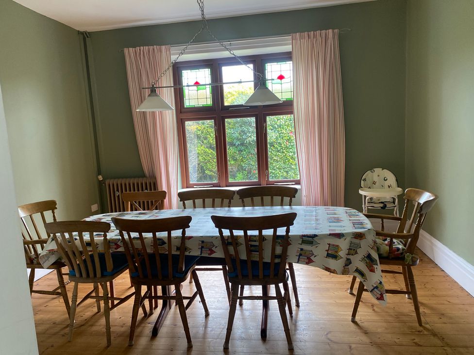 A dining room with a table and chairs at Kenvor, Newport, Pembrokeshire