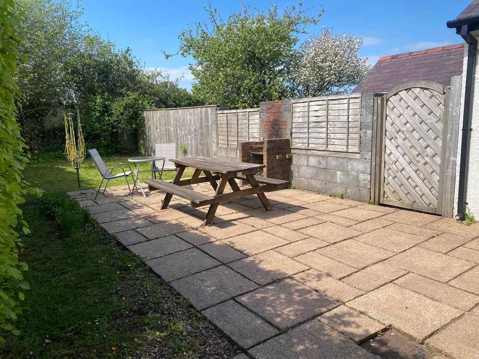 A garden with a patio table and chairs at Kenvor in Newport, Pembrokeshire