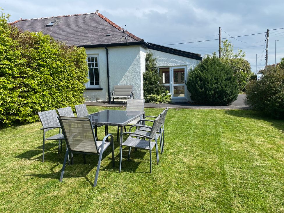 A table and chairs on grass in an outdoor area at Kenvor, Newport, Pembrokeshire