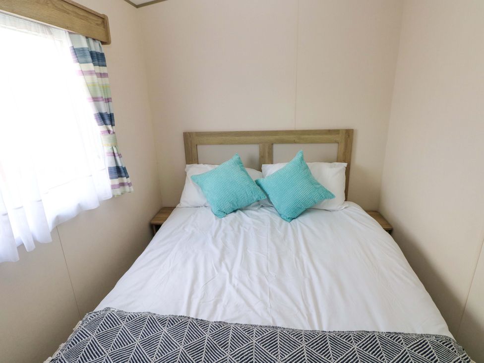 A bedroom featuring a bed with pillows at 82 Manorbier Park in Manorbier