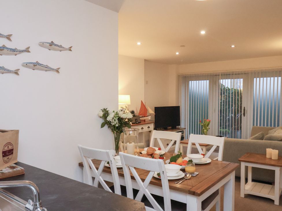A dining area with a table and chairs at One Union Mill - garden apartment in Whitby
