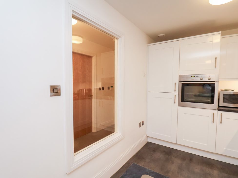 A kitchen with an oven and cabinets at One Union Mill - garden apartment in Whitby