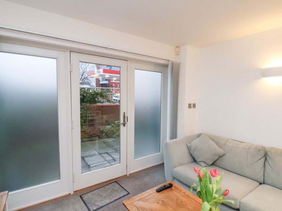 A living room with a sofa and coffee table at One Union Mill - garden apartment Whitby